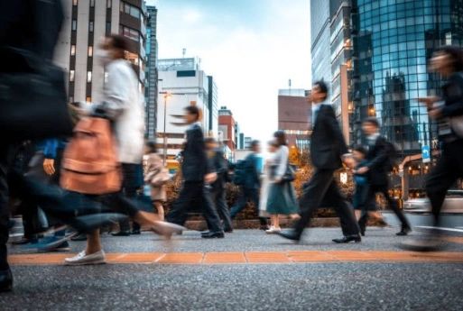 Crowd walking past digital signage